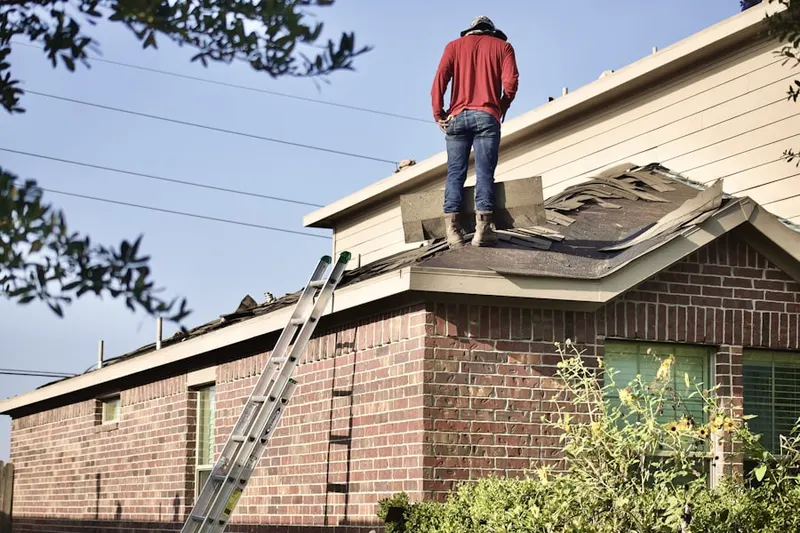 Professional roofer working on a residential roof in Oaks of Devonshire